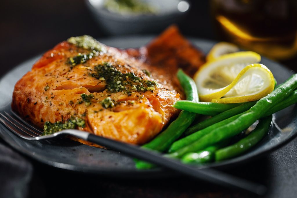 Closeup of baked salmon fish with green beans